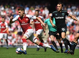 Arsenal v West Ham United 2017-18 Collection: Arsenal's Aaron Ramsey Faces Off Against West Ham's Mark Noble in Premier League Clash