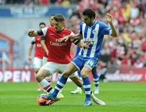 Images Dated 12th April 2014: Arsenal's Aaron Ramsey Faces Off Against Wigan's Jordi Gomez in FA Cup Semi-Final Showdown