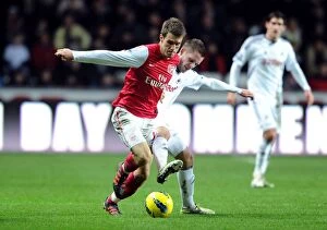 Swansea City v Arsenal 2011-12 Collection: Arsenal's Aaron Ramsey Fends Off Gylfi Sigurdsson's Challenge During Swansea Clash