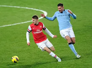 Arsenal's Aaron Ramsey Fends Off Manchester City's Javi Garcia in Intense Premier League Clash