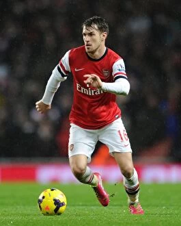 Images Dated 23rd December 2013: Arsenal's Aaron Ramsey Fights for Possession against Chelsea in Premier League Clash (2013-14)
