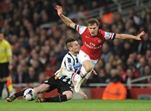 Images Dated 28th April 2014: Arsenal's Aaron Ramsey Fouls by Newcastle's Mathieu Debuchy: Intense Moment from the 2013/14