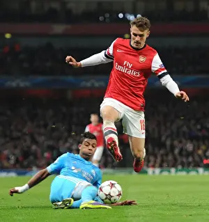 Arsenal V Marseille 2013-14 Prints: Arsenal's Aaron Ramsey Leaps Past Mario Lemina in Champions League Clash