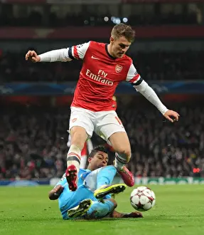 Arsenal's Aaron Ramsey Leaps Past Marseille's Mario Lemina in Champions League Clash