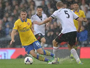 Fulham F C Prints: Arsenal's Aaron Ramsey Outmaneuvers Fulham's Brede Hangeland in Premier League Clash