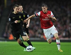 Wigan Athletic Collection: Arsenal's Aaron Ramsey Outmaneuvers James McArthur: A Premier League Clash