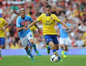 Arsenal's Aaron Ramsey Outmaneuvers Napoli's Valon Behrami during the 2013 Emirates Cup Match