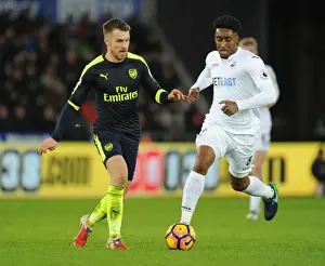 Arsenal's Aaron Ramsey Outmaneuvers Swansea's Leroy Fer in Premier League Clash