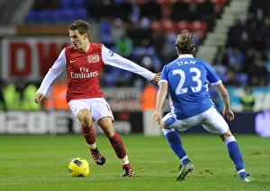 Wigan Athletic V Arsenal 2011-12 Prints: Arsenal's Aaron Ramsey Outmaneuvers Wigan's Ronnie Stam in Premier League Clash (December 2011)