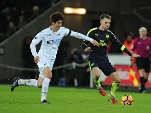 Swansea City V Arsenal - 2016-17 Prints: Arsenal's Aaron Ramsey Outwits Ki Sung-Yueng in Premier League Clash