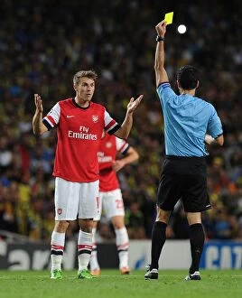 Uefa Champions Laegue Collection: Arsenal's Aaron Ramsey Shown Yellow Card by Referee Carlos Velasco Carballo in Champions League