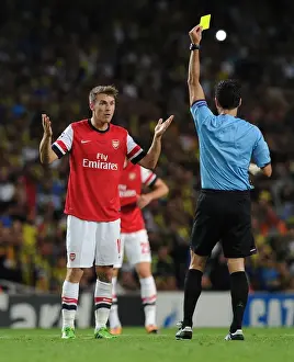 Arsenal V Fenerbahce 2013-14 Prints: Arsenal's Aaron Ramsey Shown Yellow Card by Referee Carlos Velasco Carballo in Champions League Clash vs Fenerbahce
