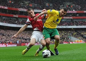 Images Dated 13th April 2013: Arsenal's Aaron Ramsey Tackles Norwich's Robert Snodgrass in Premier League Clash