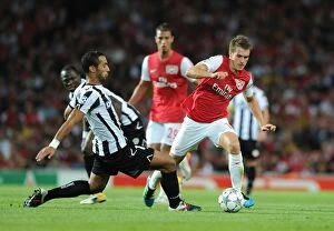 Arsenal v Udinese 2011-12 Collection: Arsenal's Aaron Ramsey vs. Medhi Benatia: Clash in the 2011 Champions League Play-Off