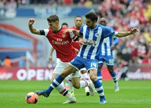 Arsenal V Wigan Athletic - FA Cup Semi Final 2014 Prints: Arsenal's Aaron Ramsey vs. Wigan's Jordi Gomez: A FA Cup Semi-Final Battle