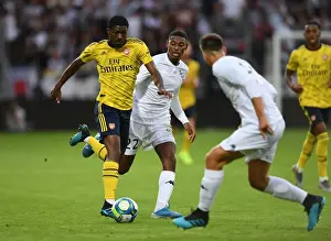 Angers SCO V Arsenal 2019-20 Prints: Arsenal's Ainsley Maitland-Niles Faces Off Against Jeff Reine-Adelaide in Angers Friendly