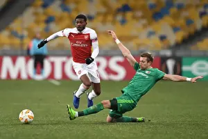FC Vorskla Poltava V Arsenal 2018-19 Prints: Arsenal's Ainsley Maitland-Niles Faces Off Against Vorskla Poltava's Lurii Kolomoets in Europa League Clash