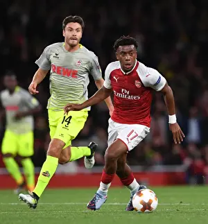 Arsenal V FC Köln 2017-18 Prints: Arsenal's Alex Iwobi Clashes with Jonas Hector in Europa League Showdown