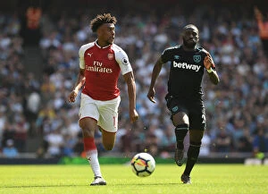 Arsenal v West Ham United 2017-18 Collection: Arsenal's Alex Iwobi Clashes with West Ham's Arthur Masuaku in Premier League Showdown