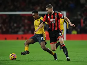 Arsenal's Alex Iwobi Faces Off Against Bournemouth's Simon Francis in Premier League Clash