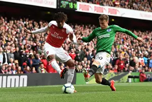 Arsenal V Brighton And Hove Albion 2018-19 Prints: Arsenal's Alex Iwobi Faces Off Against Brighton's Solly March in Intense Premier League Clash