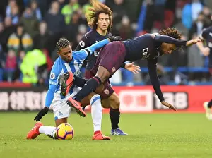Arsenal's Alex Iwobi Faces Off Against Huddersfield's Juninho Bacuna in Premier League Clash