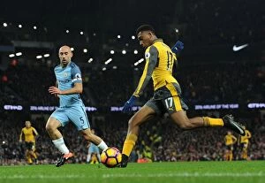 Manchester City v Arsenal 2016-17 Collection: Arsenal's Alex Iwobi Faces Off Against Manchester City's Pablo Zabaleta in Premier League Showdown