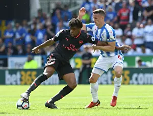 Huddersfield Town V Arsenal 2017-18 Prints: Arsenal's Alex Iwobi Fends Off Huddersfield's Jonathan Hogg During Premier League Clash