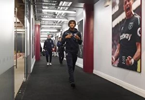 West Ham United v Arsenal 2018-19 Collection: Arsenal's Alex Iwobi Heads to the Changing Room before West Ham Clash