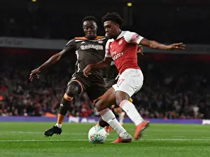 Arsenal V Brentford - Carabao Cup 2018-19 Prints: Arsenal's Alex Iwobi Outmaneuvers Brentford's Moses Odubajo in Carabao Cup Clash