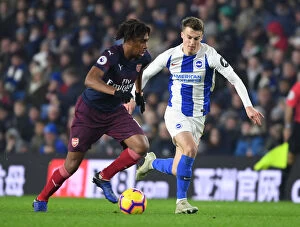Brighton & Hove Albion v Arsenal 2018-19 Collection: Arsenal's Alex Iwobi Outmaneuvers Brighton's Solly March in Premier League Clash