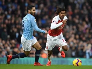 Manchester City v Arsenal 2018-19 Collection: Arsenal's Alex Iwobi Outmaneuvers Manchester City's Ilkay Gundogan in Premier League Clash