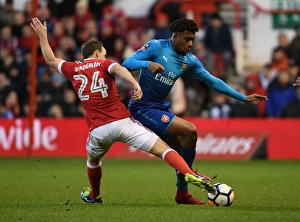 Nottingham Forest V Arsenal FA Cup 3rd Round 2017-18 Prints: Arsenal's Alex Iwobi Outmaneuvers Nottingham Forest's David Vaughan in FA Cup Clash