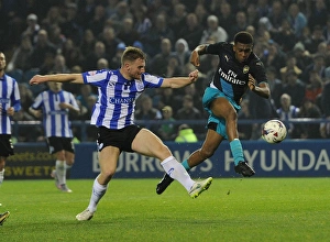 Sheffield Wednesday V Arsenal - Capital One Cup 2015-16 Prints: Arsenal's Alex Iwobi vs. Tom Lees: A Fierce Face-Off in the Capital One Cup Clash