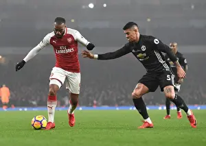 Arsenal V Manchester United 2017-18 Prints: Arsenal's Alex Lacazette Clashes with Manchester United's Marcos Rojo in Premier League Showdown