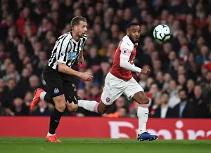 Arsenal's Alex Lacazette Faces Off Against Newcastle's Florian Lejeune in Premier League Clash
