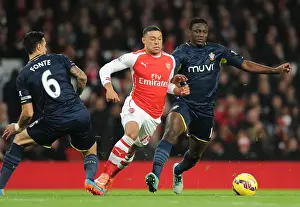 Arsenal V Southampton 2014-15 Prints: Arsenal's Alex Oxlade-Chamberlain Dashes Past Southampton's Jose Fonte and Victor Wanyama