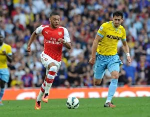 Images Dated 16th August 2014: Arsenal's Alex Oxlade-Chamberlain Faces Off Against Crystal Palace's Joel Ward