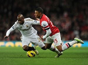 Arsenal v Swansea 2012-13 Collection: Arsenal's Alex Oxlade-Chamberlain Faces Off Against Swansea's Dwight Tiendalli in Premier League