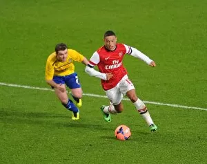 Images Dated 24th January 2014: Arsenal's Alex Oxlade-Chamberlain Faces Off Against Coventry's John Fleck in FA Cup Fourth Round