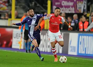Anderlecht V Arsenal 2014-15 Prints: Arsenal's Alex Oxlade-Chamberlain Faces Off Against Anderlecht's Steven Defour in Champions League Clash