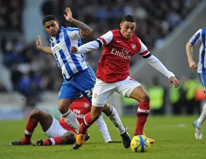Brighton And Hove Albion V Arsenal FA Cup 2012-13 Prints: Arsenal's Alex Oxlade-Chamberlain Faces Off Against Brighton's Liam Bridcutt in FA Cup Clash