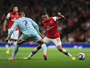 Arsenal V Coventry City - Capital One Cup 2012-13 Prints: Arsenal's Alex Oxlade-Chamberlain Faces Off Against Coventry's Jordan Clarke in Capital One Cup Clash