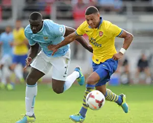 Arsenal V Manchester City Pre Season 2013-14 Prints: Arsenal's Alex Oxlade-Chamberlain Faces Off Against Manchester City's Micah Richards in Pre-Season Clash