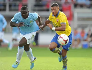 Arsenal V Manchester City Pre Season 2013-14 Prints: Arsenal's Alex Oxlade-Chamberlain Faces Off Against Micah Richards in Manchester City Pre-Season Clash