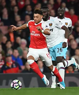 Arsenal V West Ham United 2016-17 Prints: Arsenal's Alex Oxlade-Chamberlain Faces Off Against West Ham's Arthur Masuaku in Premier League Clash