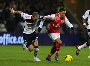 Bolton Wanderers V Arsenal 2011-12 Prints: Arsenal's Alex Oxlade-Chamberlain Outmaneuvers Bolton's Gretar Steinsson