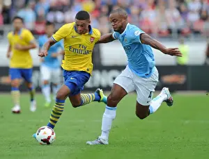 Arsenal V Manchester City Pre Season 2013-14 Prints: Arsenal's Alex Oxlade-Chamberlain Outmaneuvers Manchester City's Vincent Kompany