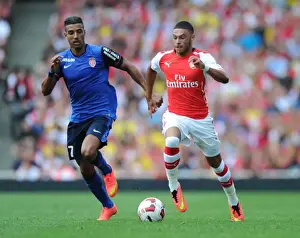 Arsenal V AS Monaco 2014-15 Prints: Arsenal's Alex Oxlade-Chamberlain Outmaneuvers AS Monaco's Nabil Dirar