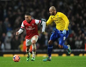 Images Dated 24th January 2014: Arsenal's Alex Oxlade-Chamberlain Outpaces Coventry's Leon Clarke in FA Cup Clash